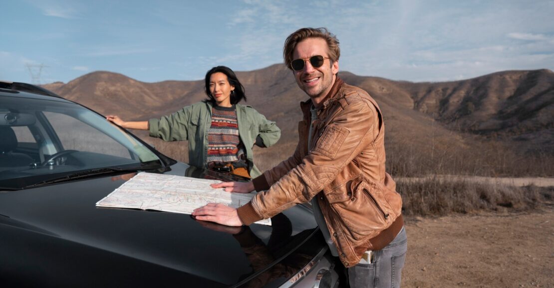 Tourist driving a rental car from DL CARS through the Moroccan desert during a road trip
