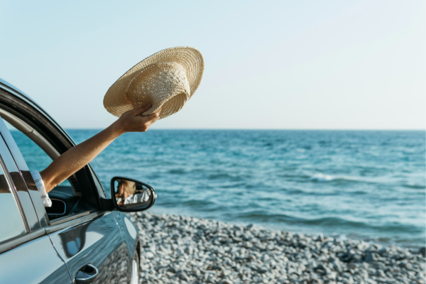 A winding coastal road along Morocco’s oceanfront with clear blue skies and rugged cliffs.